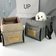 Nonslip Pet Travel Booster Seat for small pets with cozy interior and secure fit on car armrest.