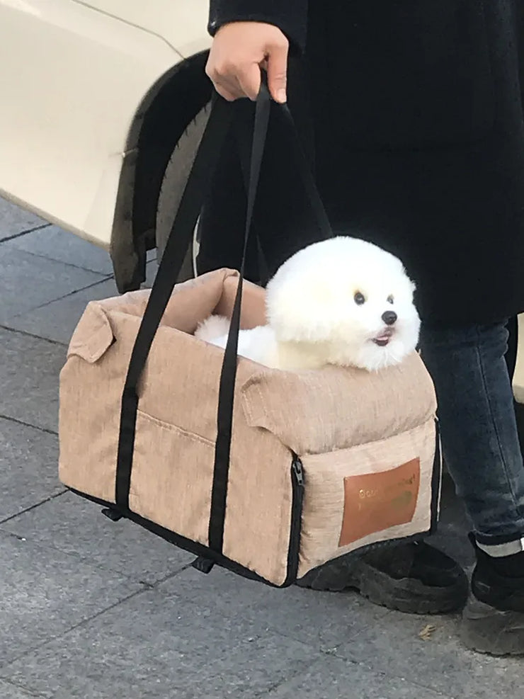 Nonslip Pet Travel Booster Seat for small dogs and cats in beige with carrying straps.