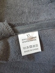 Quick-Dry Pet Bathrobe with microfiber fabric tag displaying composition and care instructions.