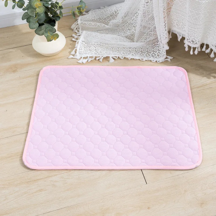 EcoComfort Washable Pee Pad & Pet Blanket in soft pink on wooden floor, eco-friendly and absorbent.