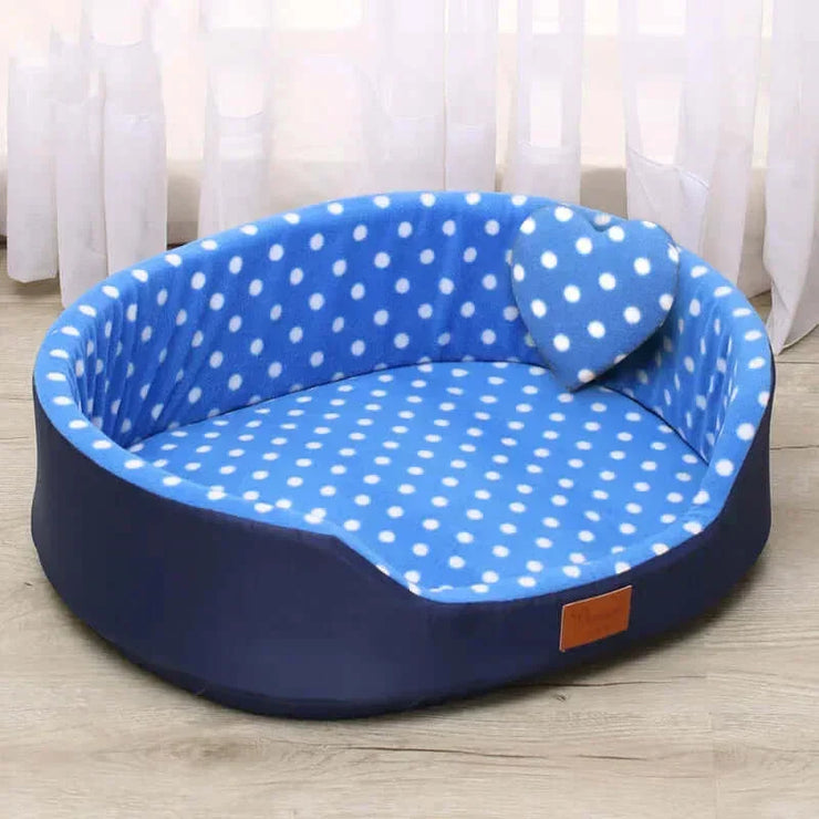 Cozy blue polka dot pet bed for dogs and cats, offering warmth and comfort.